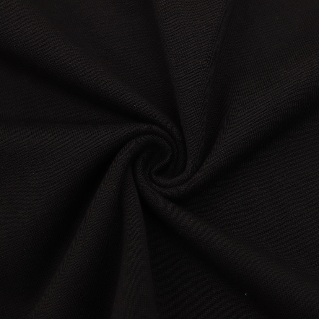Black T-shirt fabric close-up with textured knit surface