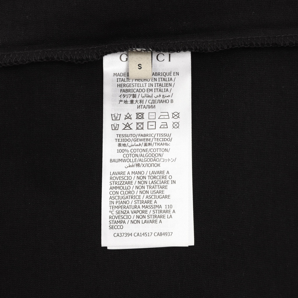 Black T-shirt care label near neck with printed Gucci branding
