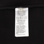 Black T-shirt care label near neck with printed Gucci branding