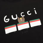 Black short-sleeve T-shirt with large Gucci logo and bear graphic
