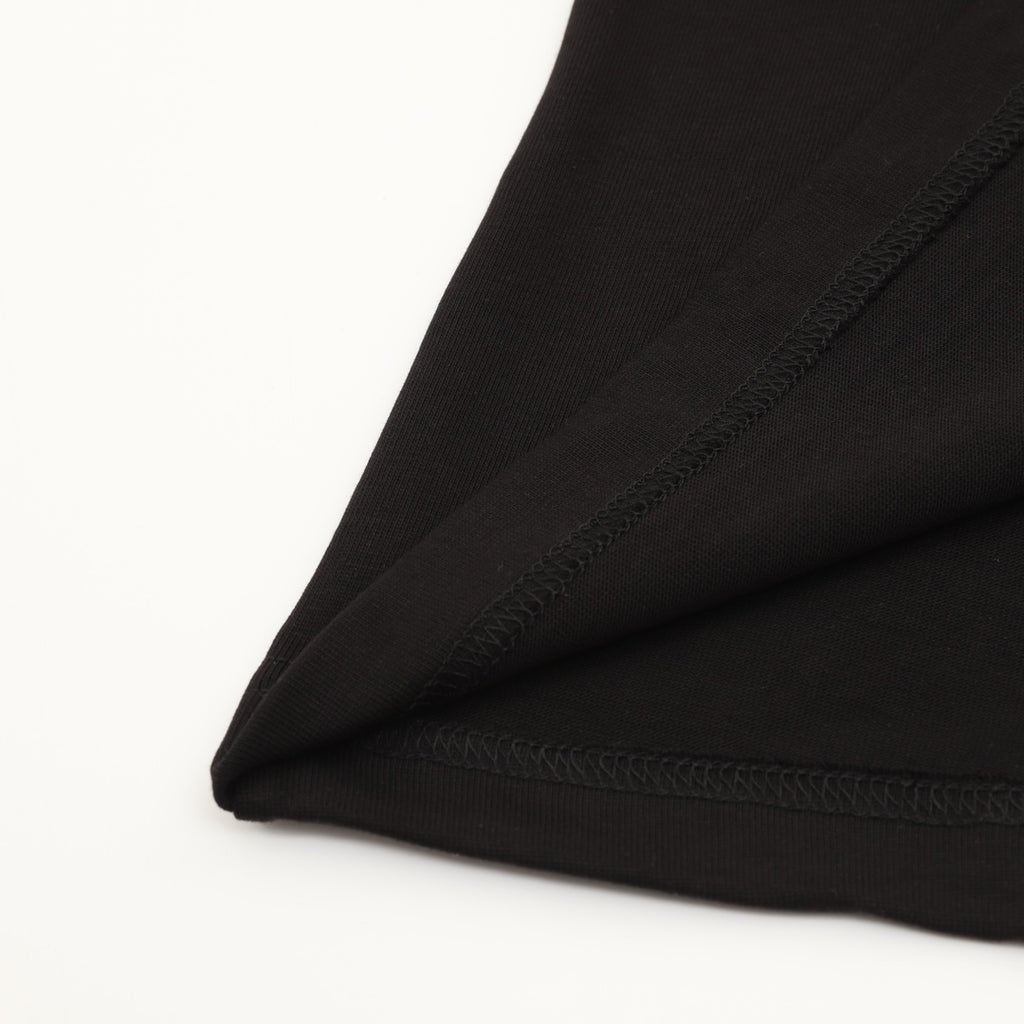Black T-shirt hem with visible double-stitch seam