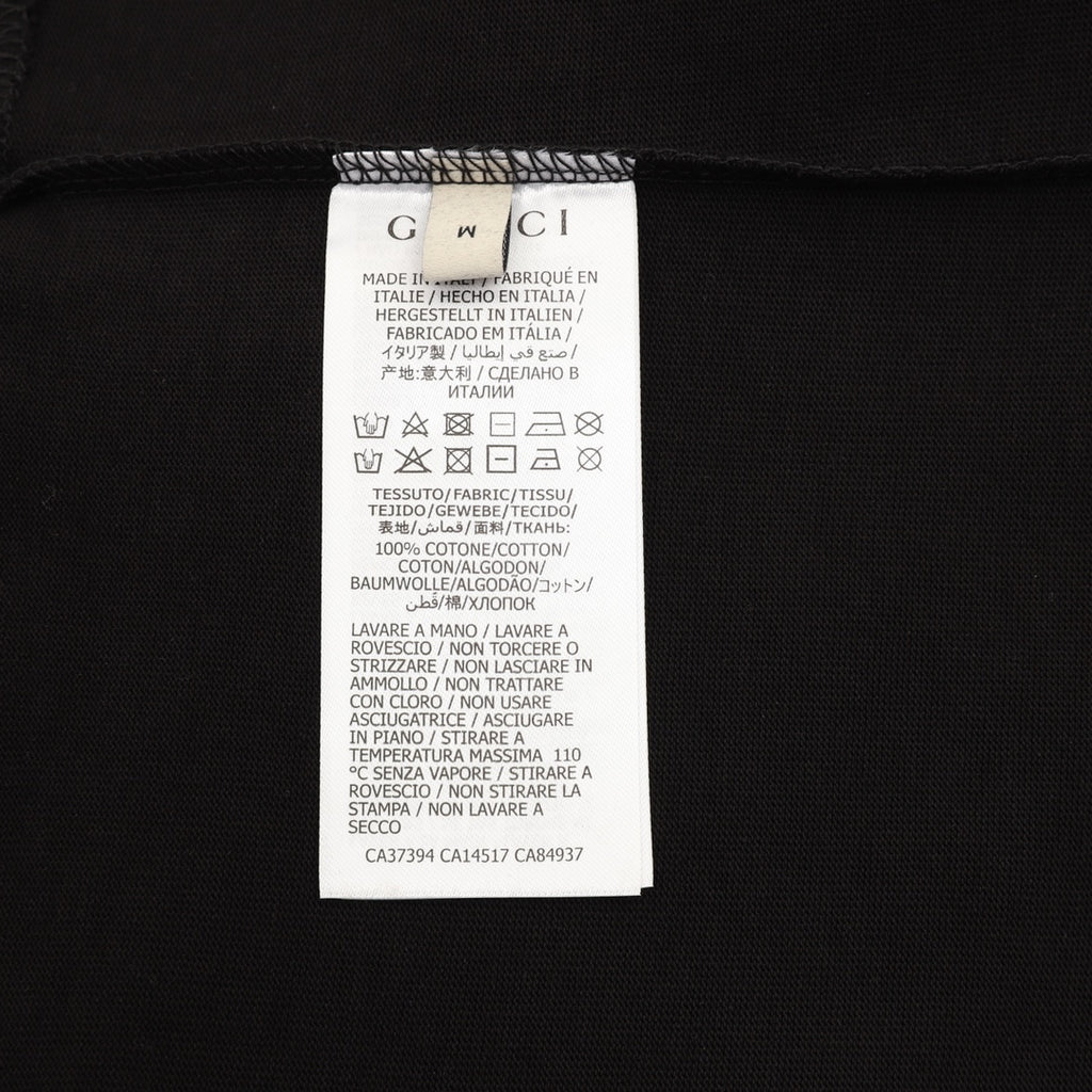 Black T-shirt care label with size and fabric instructions