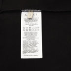 Black T-shirt care label with size and fabric instructions