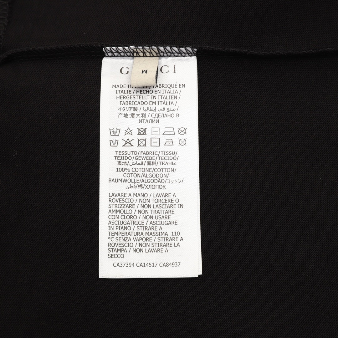 Black T-shirt care label with size and fabric instructions