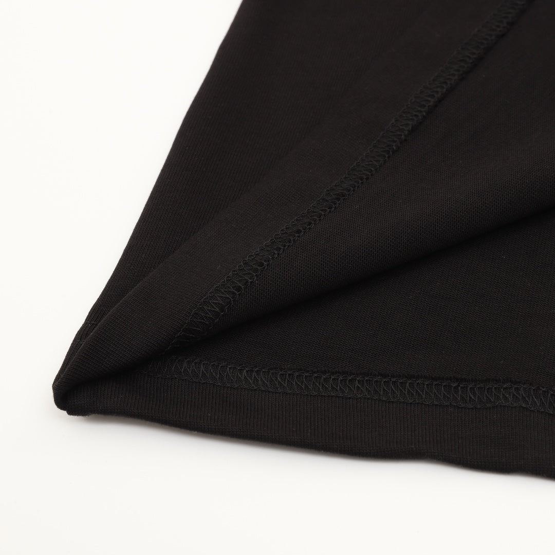 Black T-shirt corner with stitched seam and overlock detail