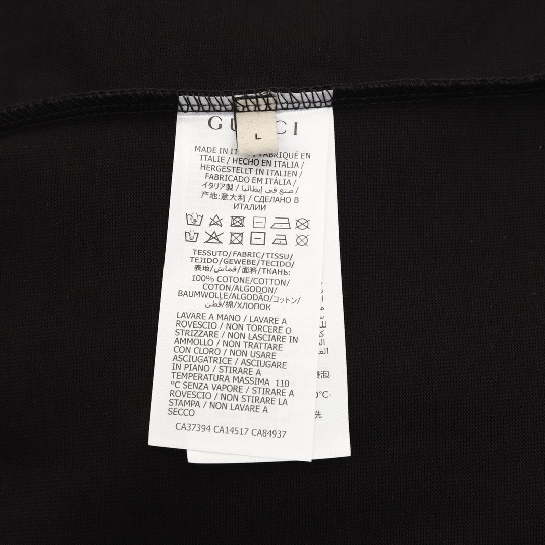 Black T-shirt with white care label and fabric composition details