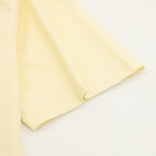 Kids pale yellow T-shirt sleeve and hem detail