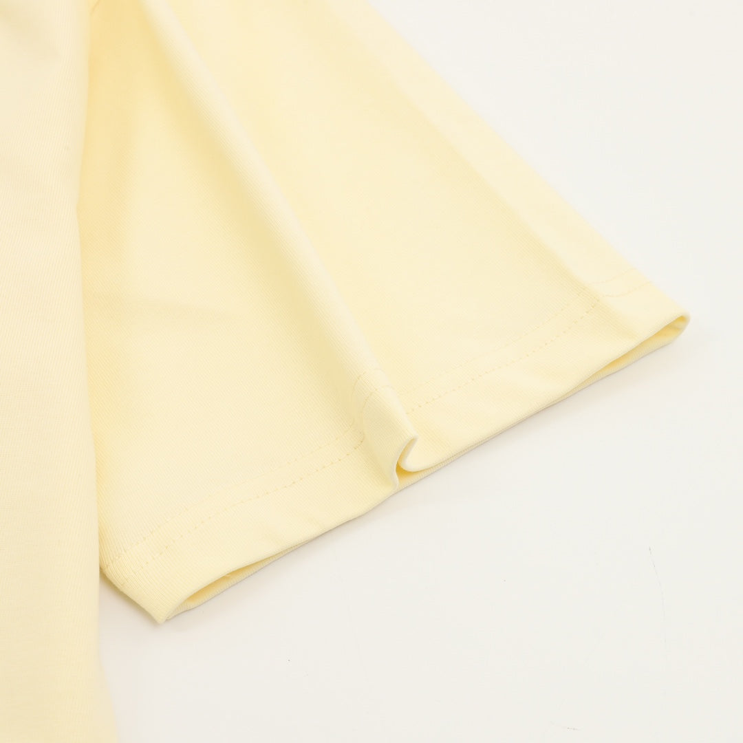 Kids pale yellow T-shirt sleeve and hem detail