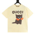 Gucci short-sleeve T-shirt in pale yellow with “GUCCI” and a black cat graphic