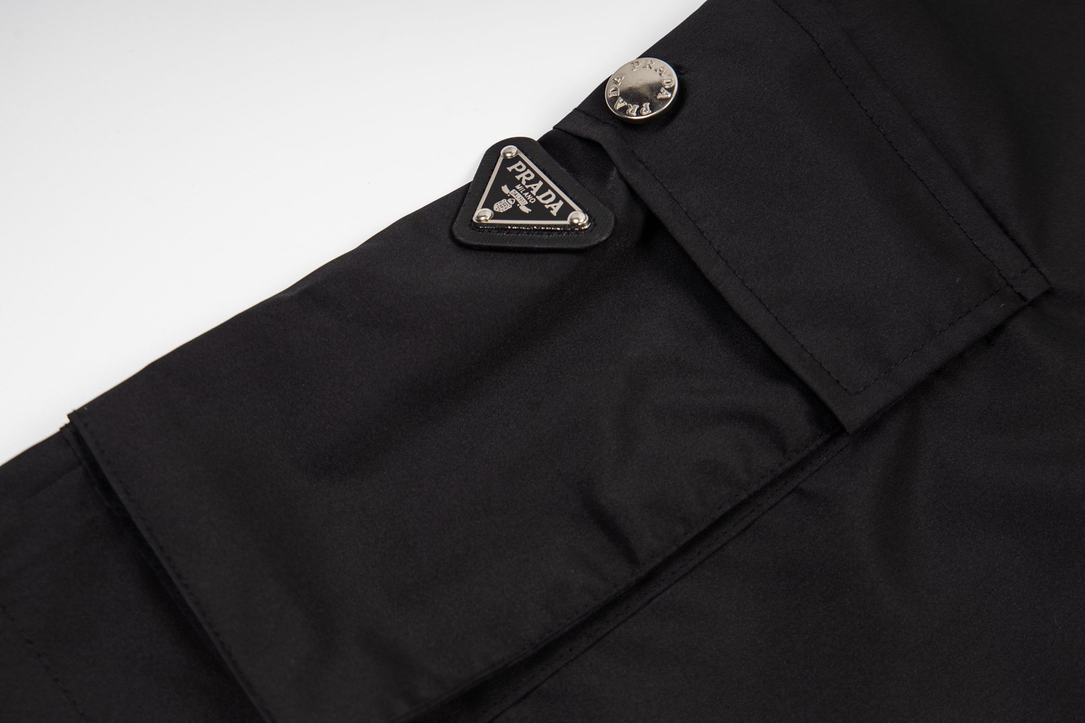 Prada black shorts with leather logo patch near waistband