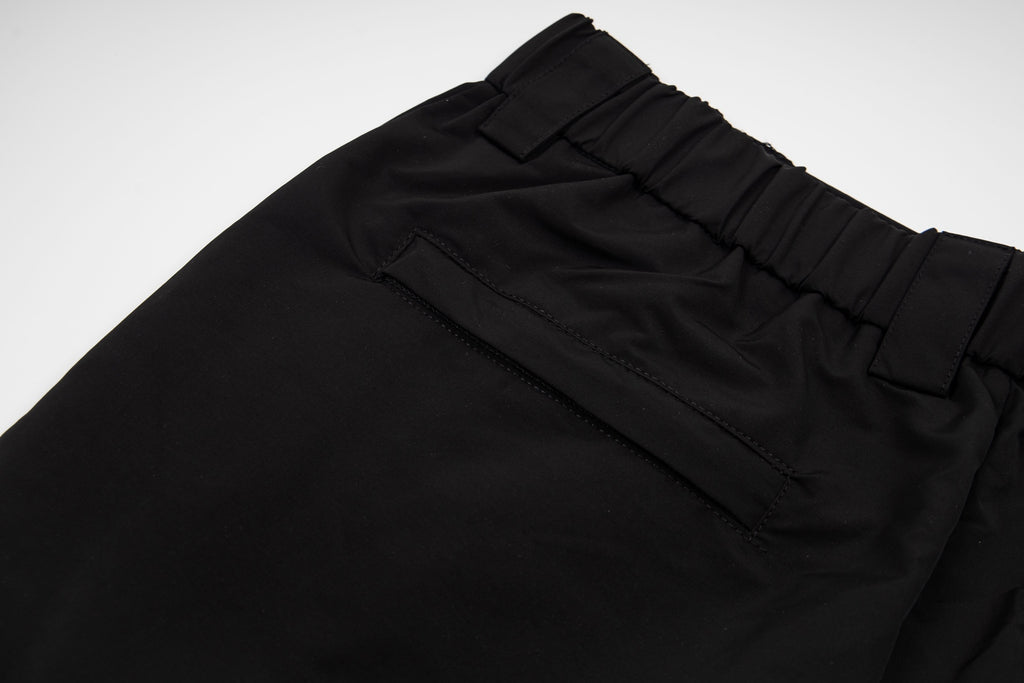 Black pants with stitched front pockets and elastic waistband