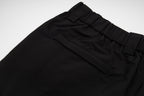 Black pants with stitched front pockets and elastic waistband