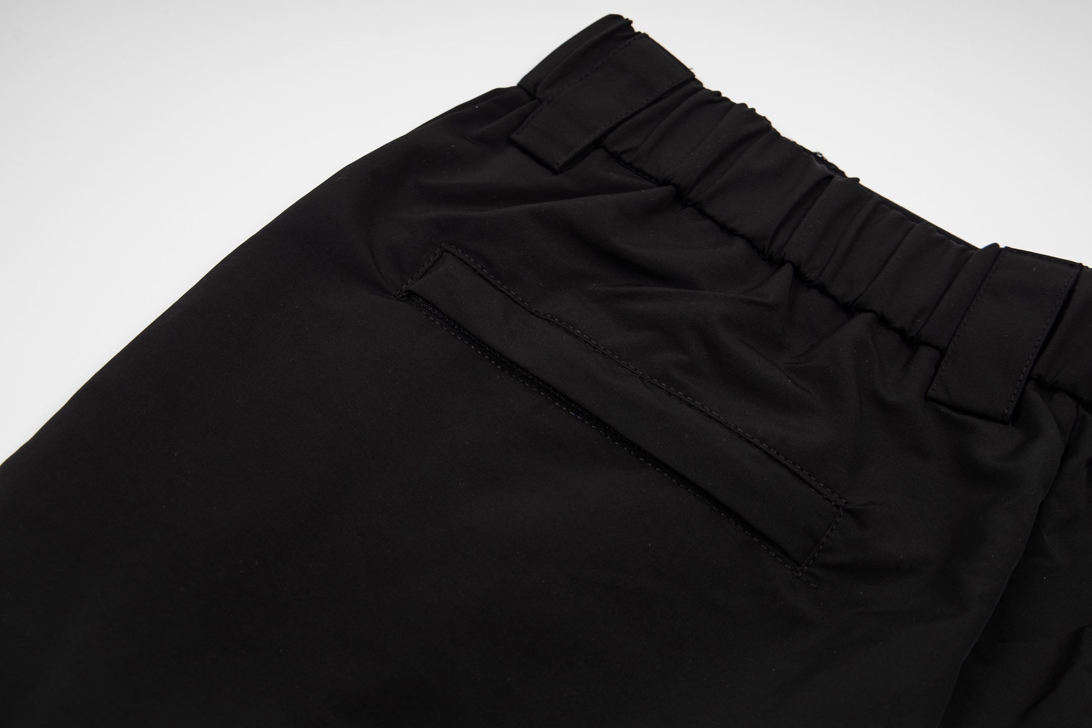 Black pants with stitched front pockets and elastic waistband