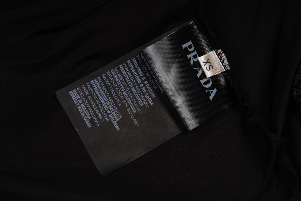 Prada care label and logo tag on black pants