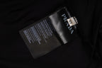 Prada care label and logo tag on black pants