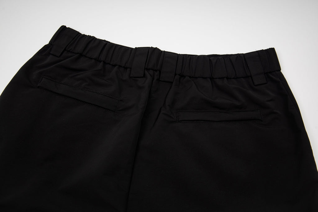 Black pants with elastic waistband and front button tab