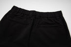 Black pants with elastic waistband and front button tab