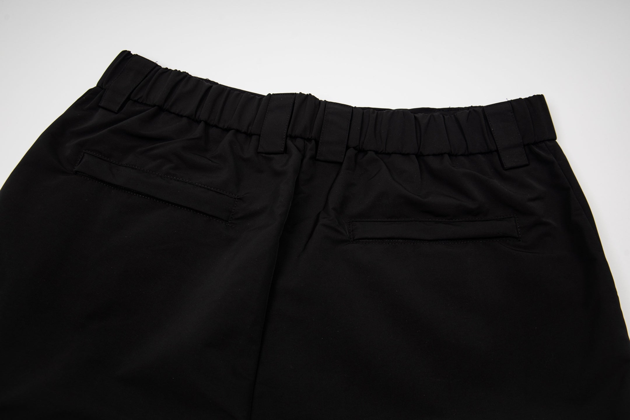 Black pants with elastic waistband and front button tab