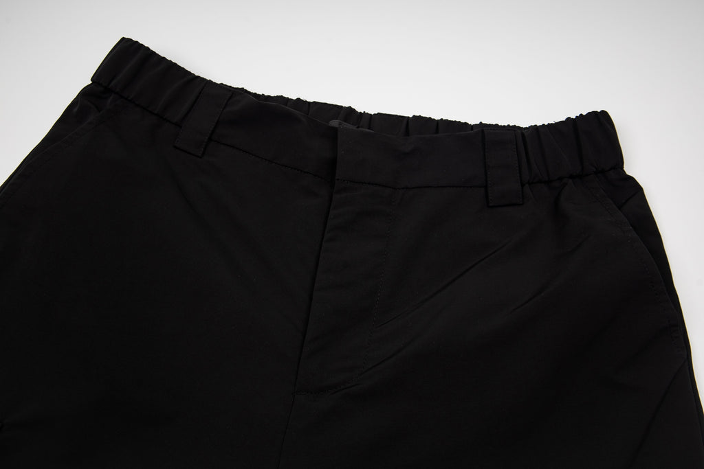 Black cargo shorts waistband with belt loops and pleated front
