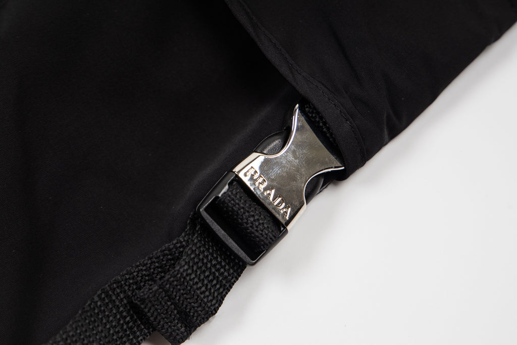 Black cargo shorts with metal logo buckle and woven strap