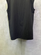 Sleeveless dark top with drapey fit and curved hemline, back view