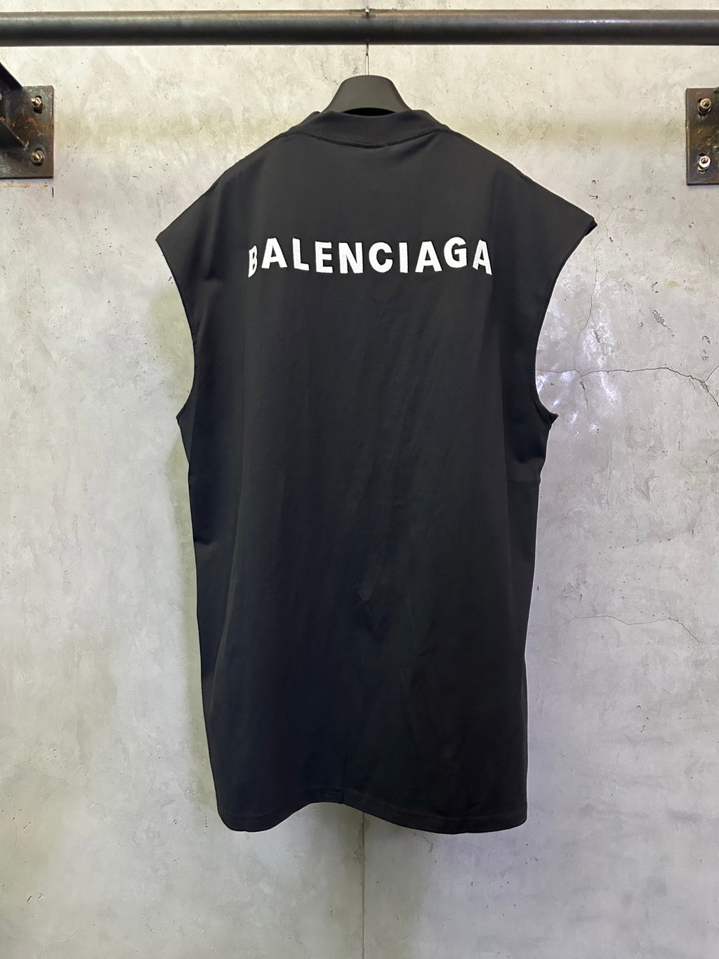 Balenciaga sleeveless top with large back logo text, dark fabric and crew neckline