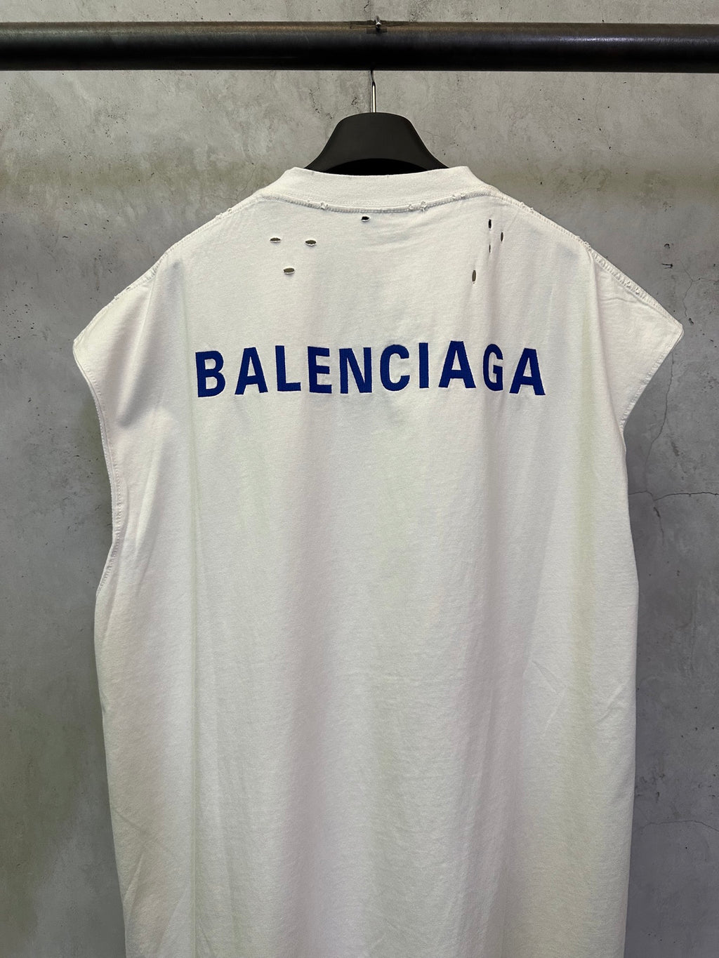 White short-sleeve T-shirt with large blue BALENCIAGA text on the back