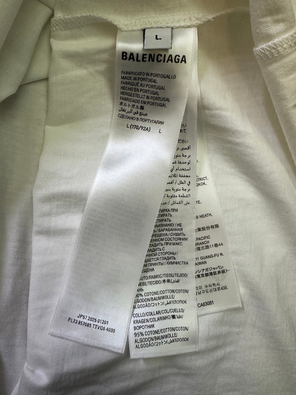 White T-shirt care label with Balenciaga branding and size L