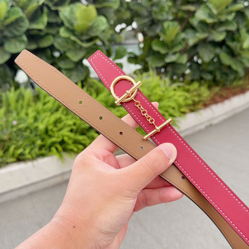 Red and tan leather belt straps with gold buckles and contrast stitching