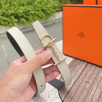 Leather belt with light strap, gold buckle hardware and chain strap, on hand