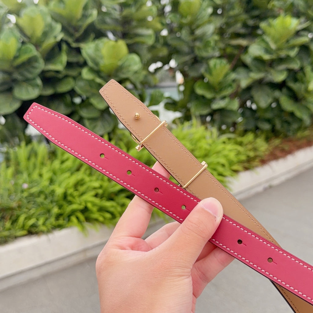 Red and tan leather belt straps with hole rows and gold buckle tabs