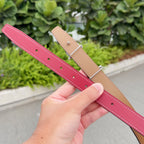 Hermes belt with burgundy leather strap and tan strap, silver pin buckle; eyelets visible