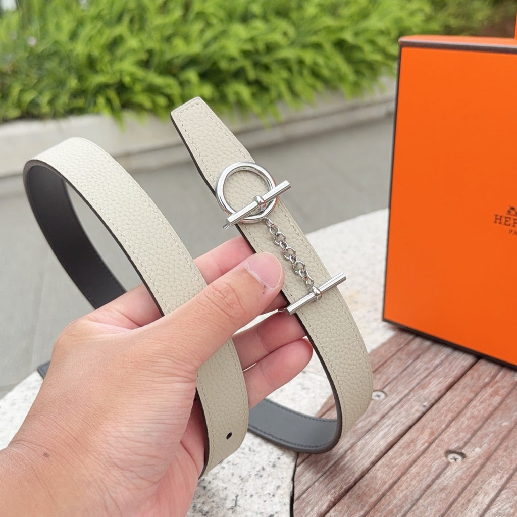 Hermes belt close-up with light beige leather, silver D-ring clasp and chain