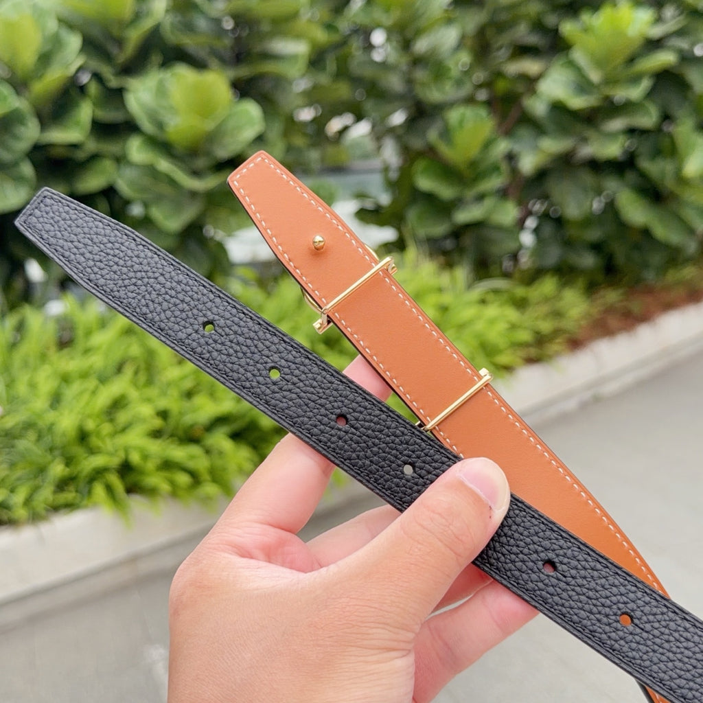 Black leather belt with tan reverse, gold-tone buckle; stitching and punched holes