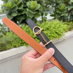 Black leather belt with tan strap and gold-tone buckle, chain link