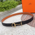 Hermes leather belt with black strap, tan lining, gold-tone buckle and chain