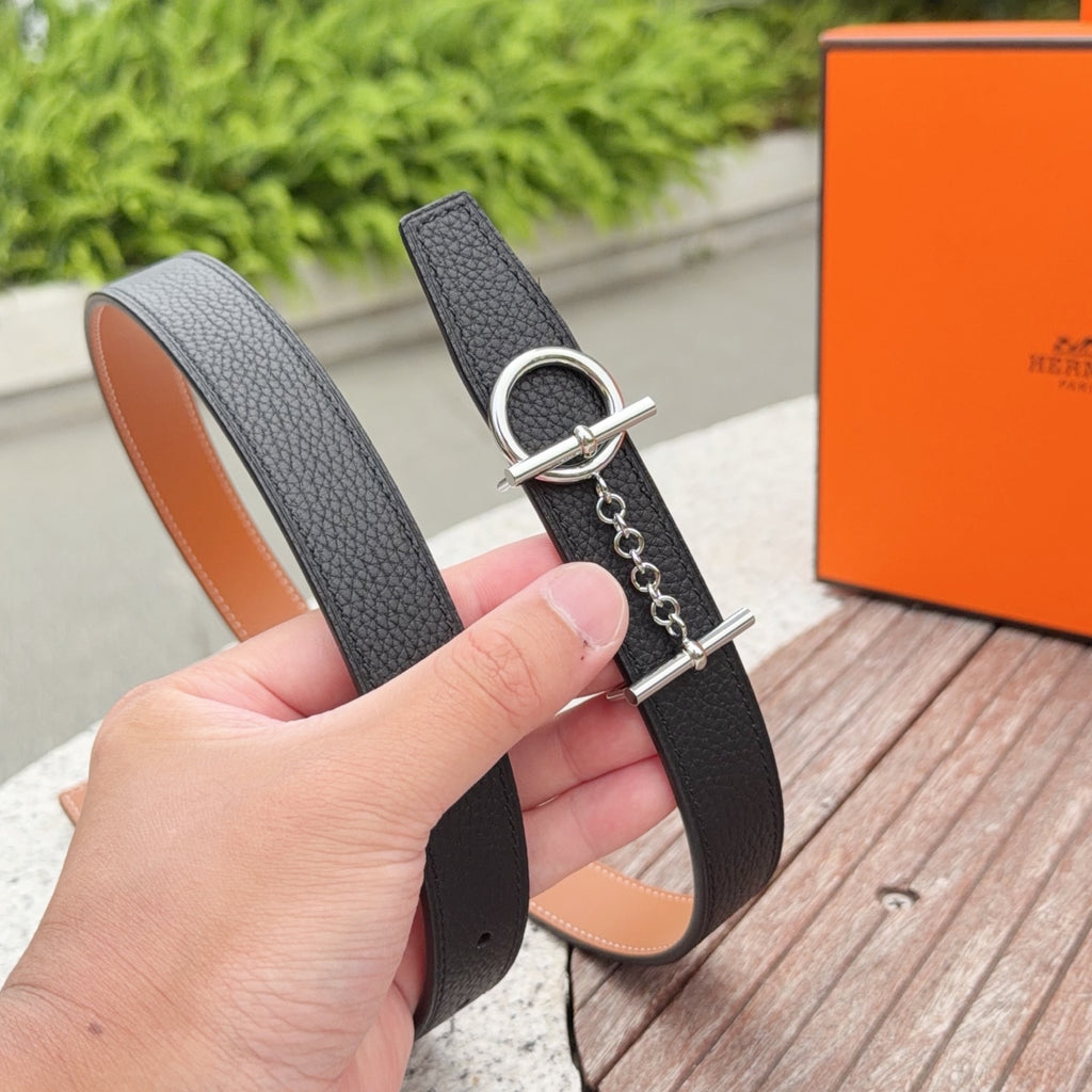 Hermes belt strap with silver oval buckle, chain attachment, and stitched edge