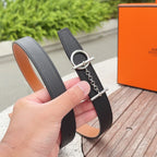 Hermes belt strap with silver oval buckle, chain attachment, and stitched edge