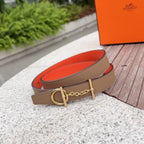 Hermes leather belt with tan strap, gold buckle hardware, and red underside