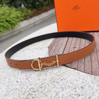 Tan leather belt with gold buckle and chain detail, black underside