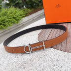 Hermes leather belt with tan strap, silver buckle ring, and chain detail