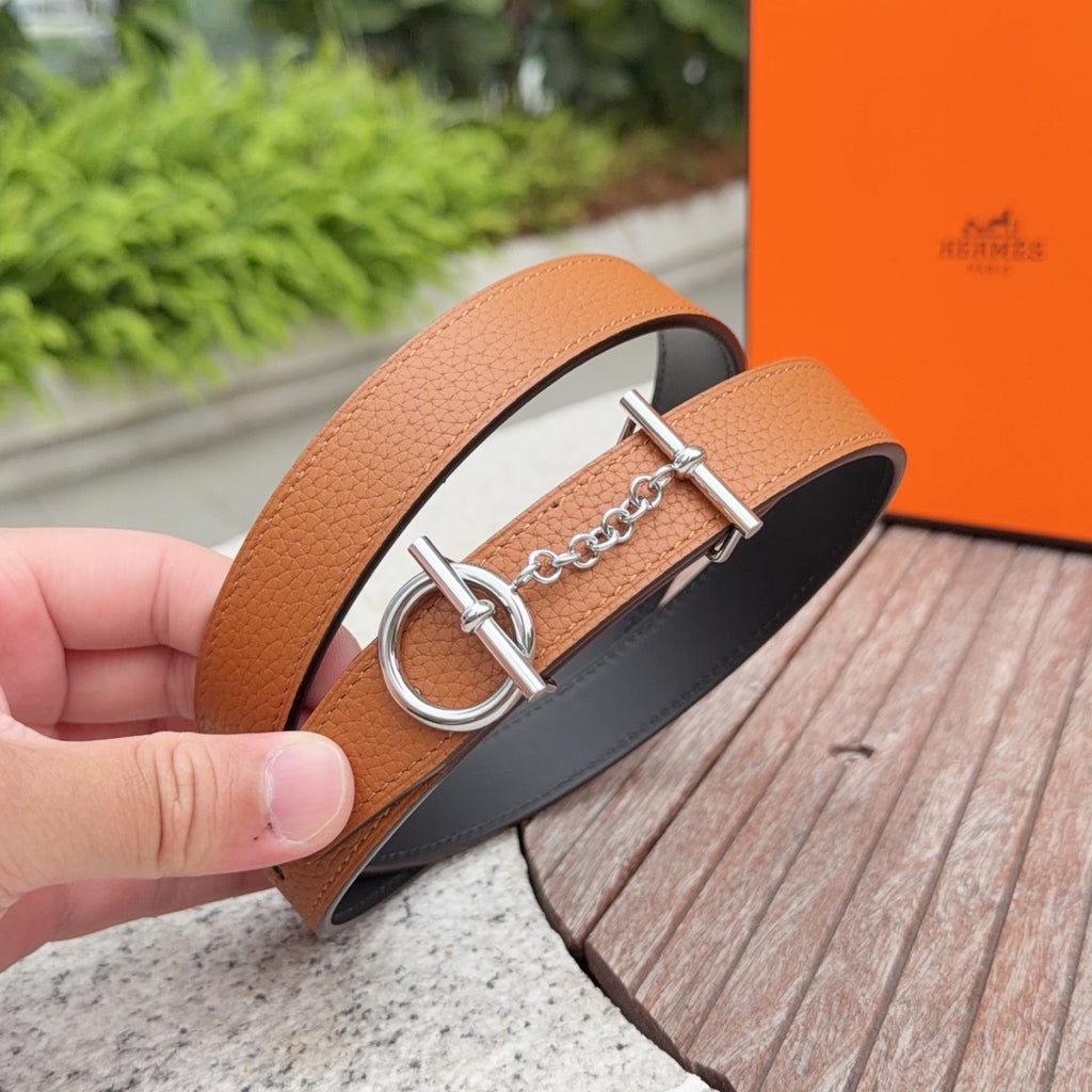 Hermes leather belt close-up with tan strap and silver double-ring buckle