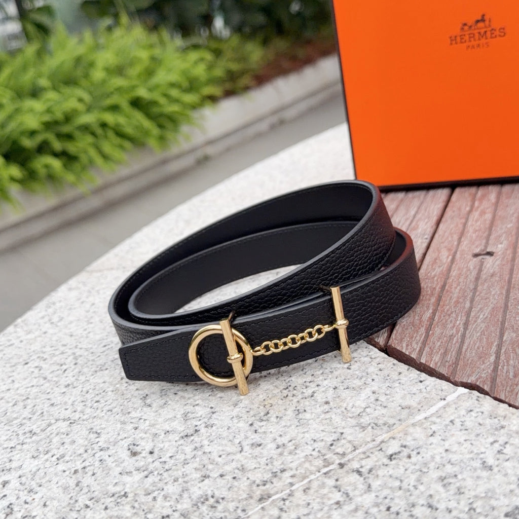 Black leather belt with gold-tone buckle and chain; close-up angle
