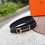 Black leather belt with gold-tone buckle and chain; close-up angle