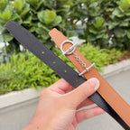 Hermes leather belt set showing tan and dark straps with silver grommets and chain