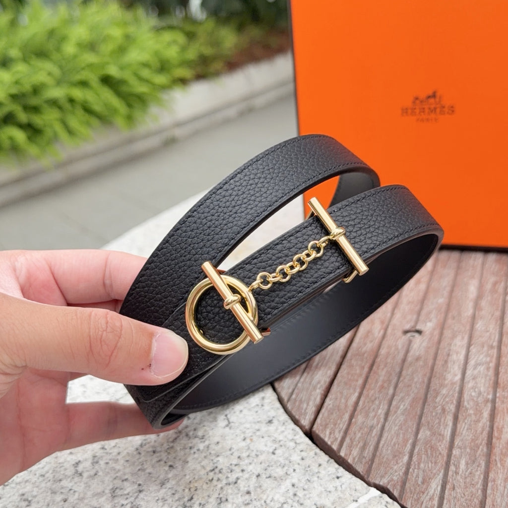 Black leather belt detail: gold ring buckle with chain and bar