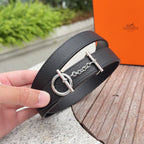Hermes belt close-up: dark leather with silver-tone D-ring, buckle, and chain