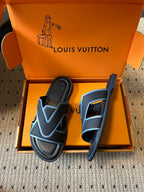Louis Vuitton slide sandals, black with light blue straps, one shown upright