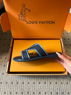 Louis Vuitton slide sandals, black with light blue logo strap, side angle