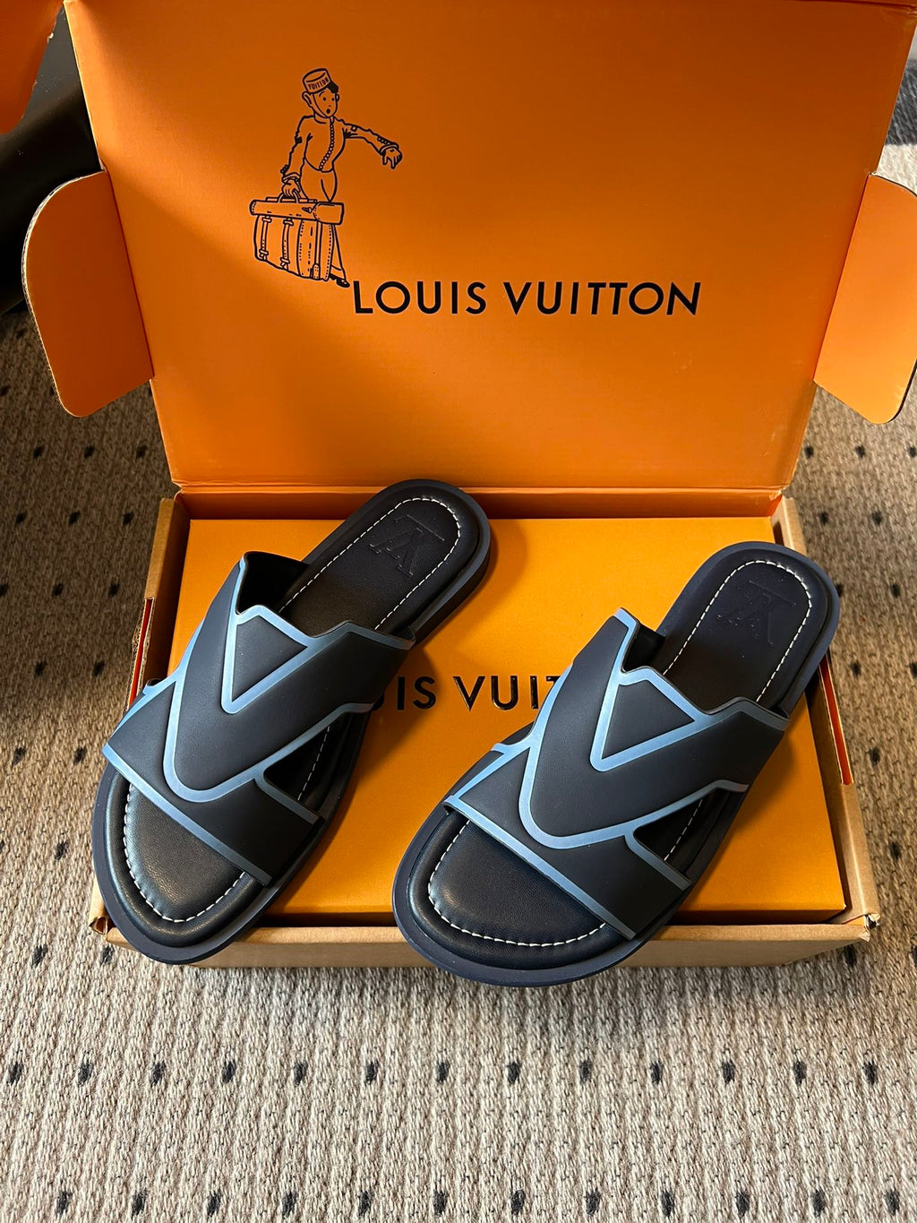 Louis Vuitton slide sandals, black with light blue V-pattern straps, open toe